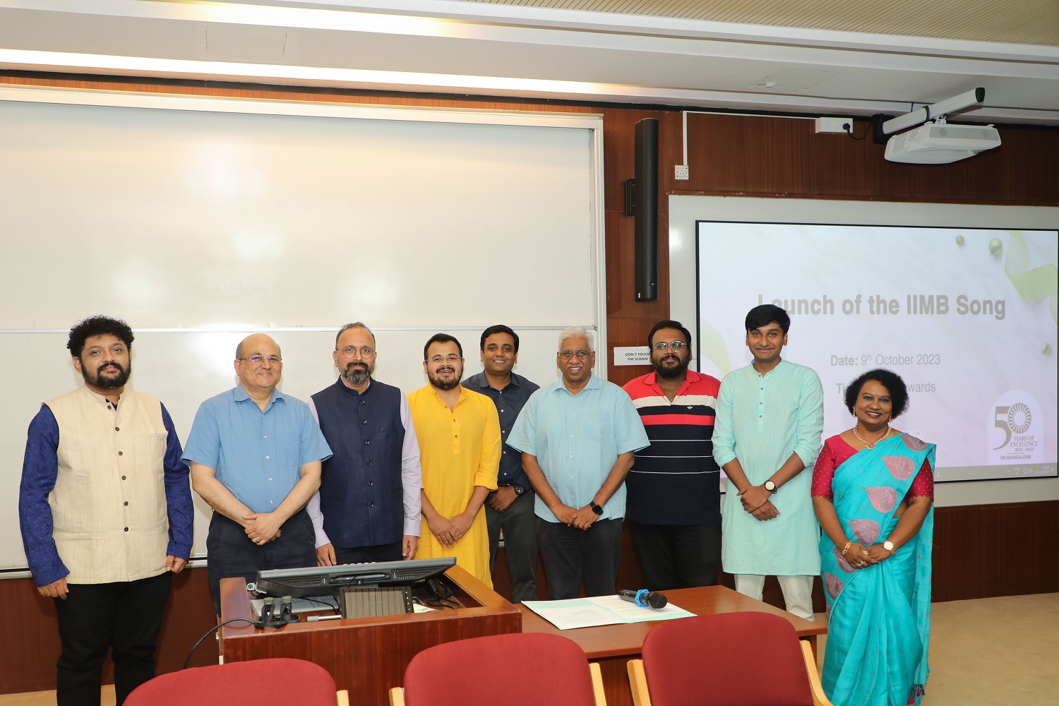 (L-R) Music Director Navneeth Sundar, IIMB Director Professor Rishikesha T Krishnan, IIMB Alumnus-Author-Entrepreneur and member of the winning team of lyricists Pashupati Davella, PGP SAC President Harsav Bessariya, PGPEM SAC President Saurav Kumar, Dean Administration Professor Rajendra K Bandi, PhD SAC President Abhishek Bhattacharjee, EPGP SAC President Govinda Raju M, and Komala Devi, Member of the Golden Jubilee Committee, after the launch of the audio track and video of the IIMB Song.